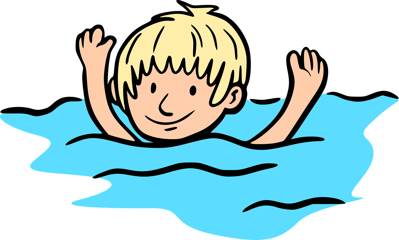 A boy swimming in a pool of water